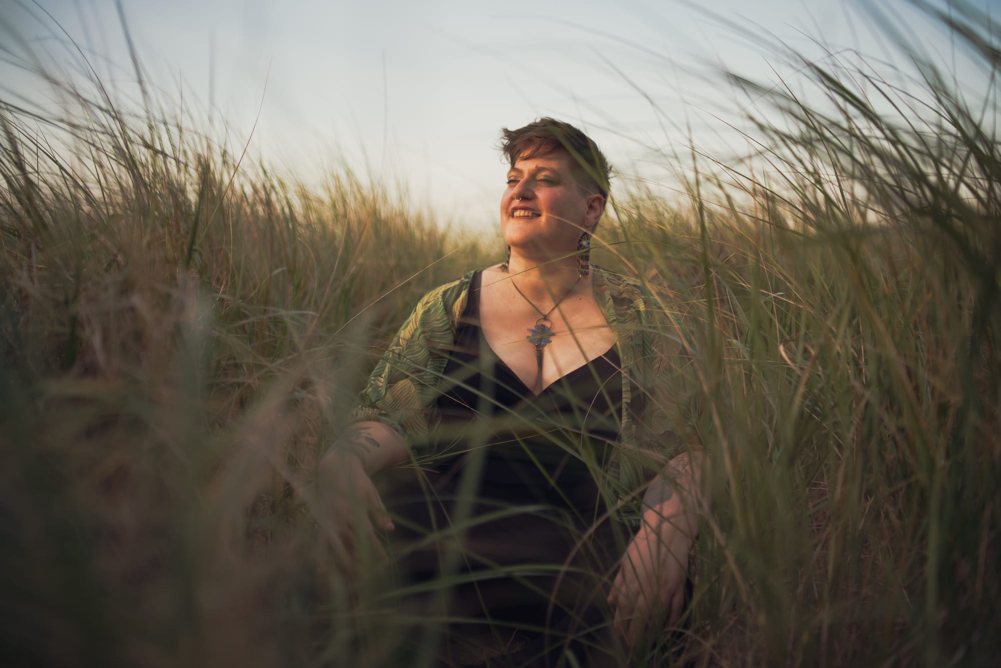 I sit cross legged in the prairie grasses at my local beach, face upturned towards the sky with eyes closed.