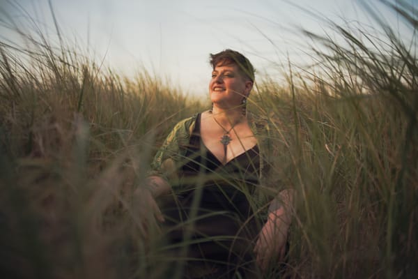 I sit cross legged in the prairie grasses at my local beach, face upturned towards the sky with eyes closed.
