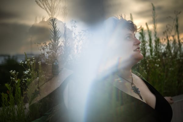 Julia looking up to the sky. A prism refracted her image in the photo, creating a soft mirrored reflection